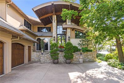 Custom 11 foot glass and wrought iron doors welcome guests. | Image 2