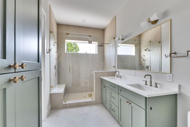 Bathroom featuring a shower stall, double vanity, and tile patterned floors | Image 30