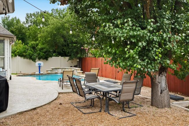 View of patio / terrace with a fenced backyard, a fenced in pool, and outdoor dining area | Image 28