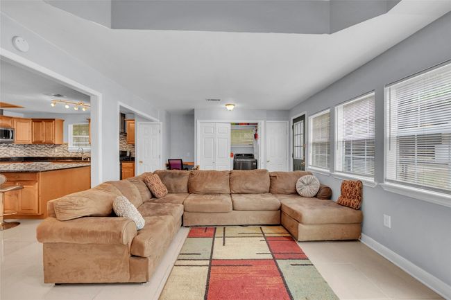 Living room featuring light tile patterned flooring and baseboards | Image 25