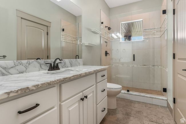 Full bath with a shower stall, toilet, and vanity | Image 26