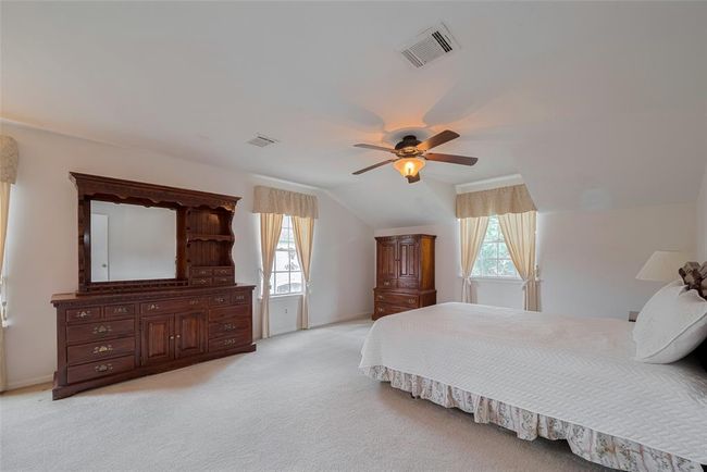 Spacious and inviting primary bedroom with abundant natural light. | Image 19