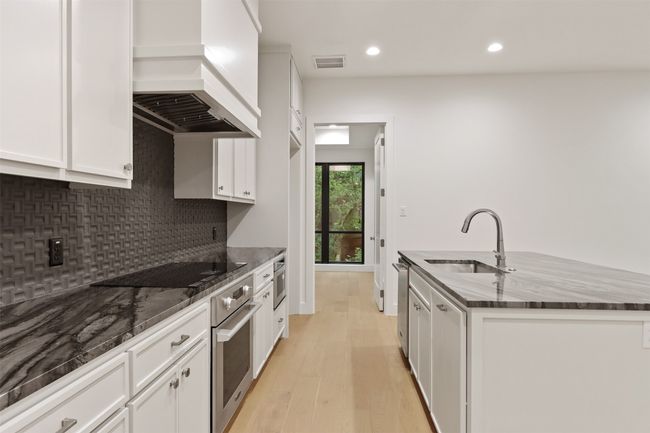Gourmet Kitchen with quartz countertops, Signature luxury stainless appliances by LG | Image 11