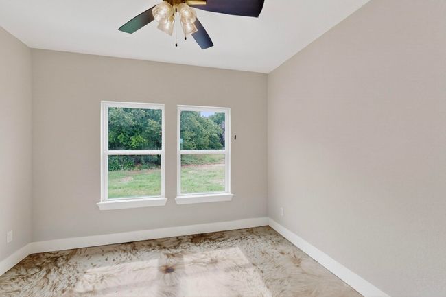 Spare room featuring ceiling fan and light carpet | Image 33