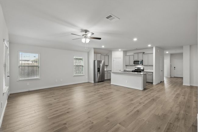 Unfurnished living room with recessed lighting, ceiling fan, and light wood finished floors | Image 17