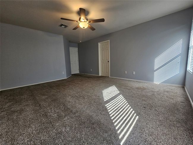 Spare room featuring ceiling fan and carpet floors | Image 15