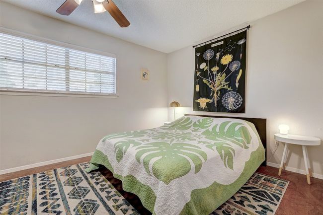 Bedroom with baseboards, ceiling fan, and a textured ceiling | Image 22