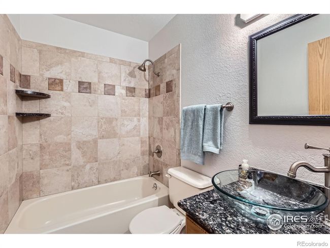 Main Bath with Updated Shower Tile & Sleek Glass Vessel Sink | Image 20