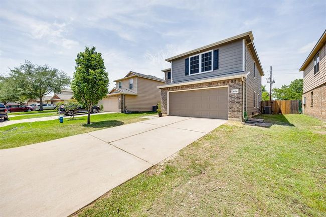 Double attached garage provides secure parking and additional storage space with convenient home access. | Image 10
