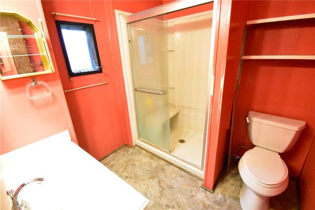 Bathroom with a shower with shower door and toilet | Image 20