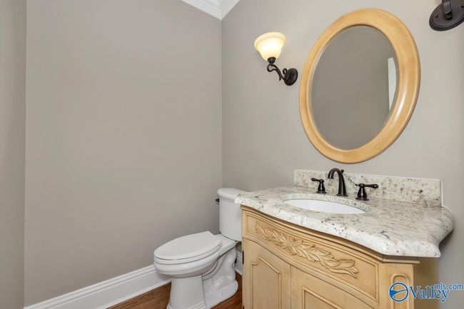 Wood flooring, single vanity, crown molding | Image 21