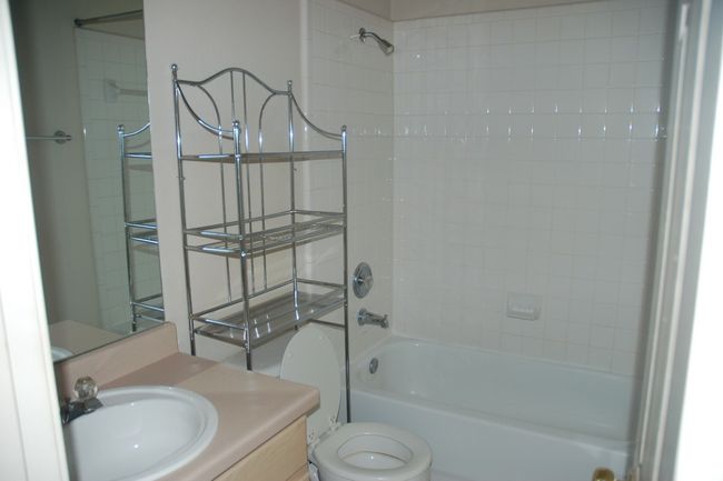 Bathroom with toilet, vanity, and tub / shower combination | Image 10