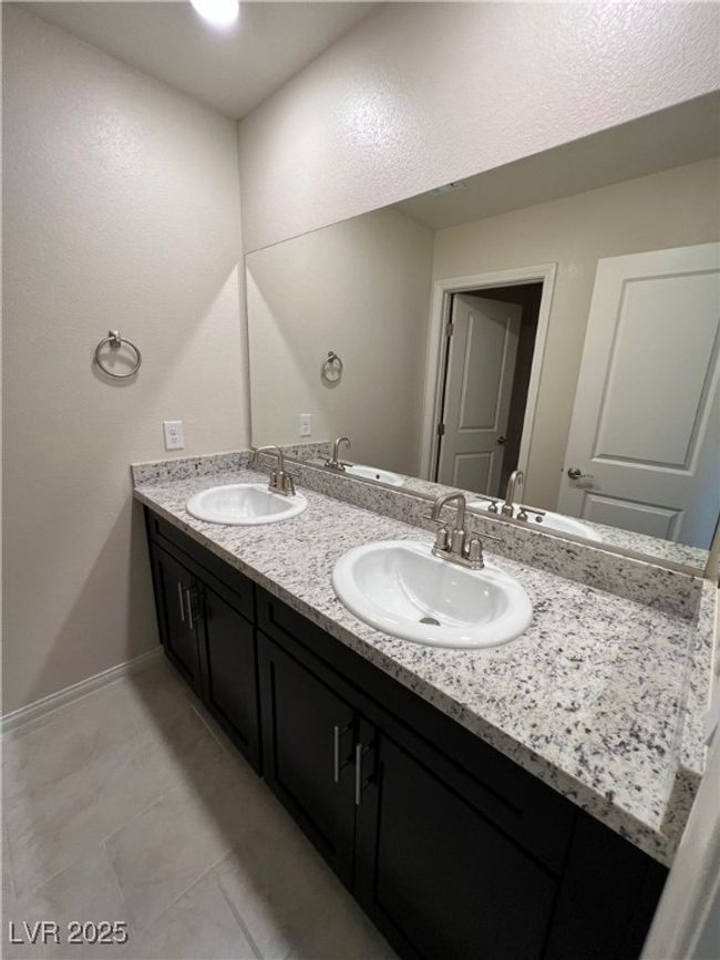 Bathroom featuring double vanity and baseboards | Image 16