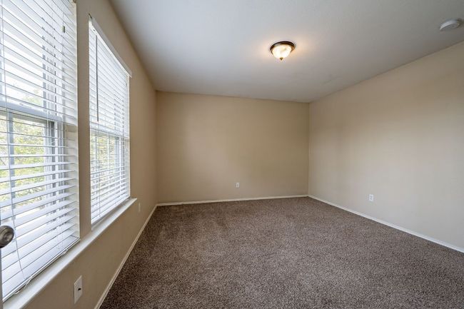 Carpeted spare room with baseboards and a smoke detector | Image 15