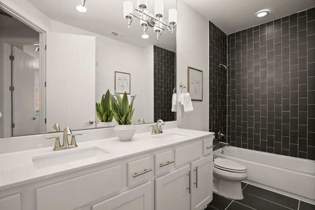 Bathroom featuring double vanity, toilet, tile patterned flooring, and shower / bathtub combination | Image 18