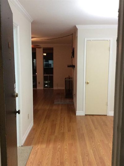 View in front door into dining room, living with fireplace and great windows. Kitchen to the left and bedrooms down the hall to the right. Notice to shining laminate floors. | Image 1