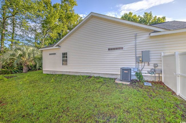 View of side of home with a central AC unit and roof with shingles | Image 8