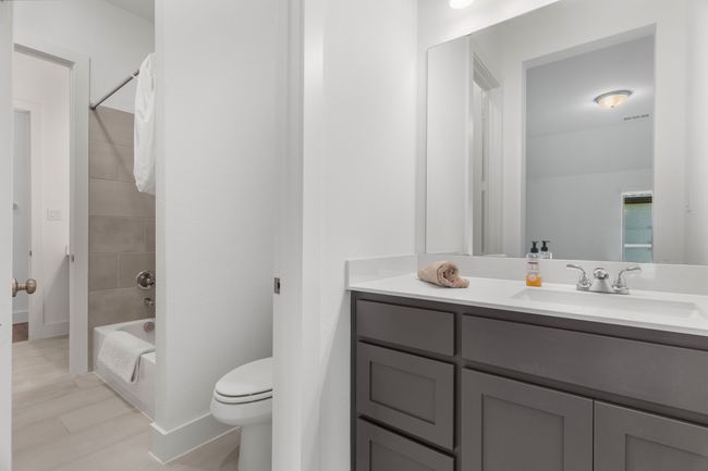 Full bath with toilet, vanity, shower / bathtub combination, and baseboards | Image 12