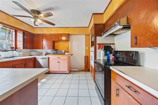 The kitchen has a built in over and a push in oven. You could easily make the wall oven into a pantry or extra cabinets. | Image 7