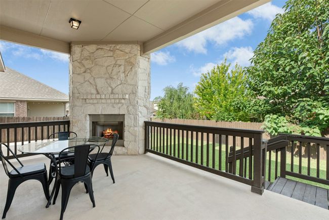 Gorgeous outdoor fireplace on raised cement deck. Private yard. | Image 27