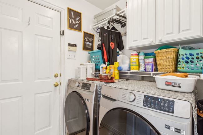 Laundry area featuring washer and clothes dryer and cabinet space | Image 25