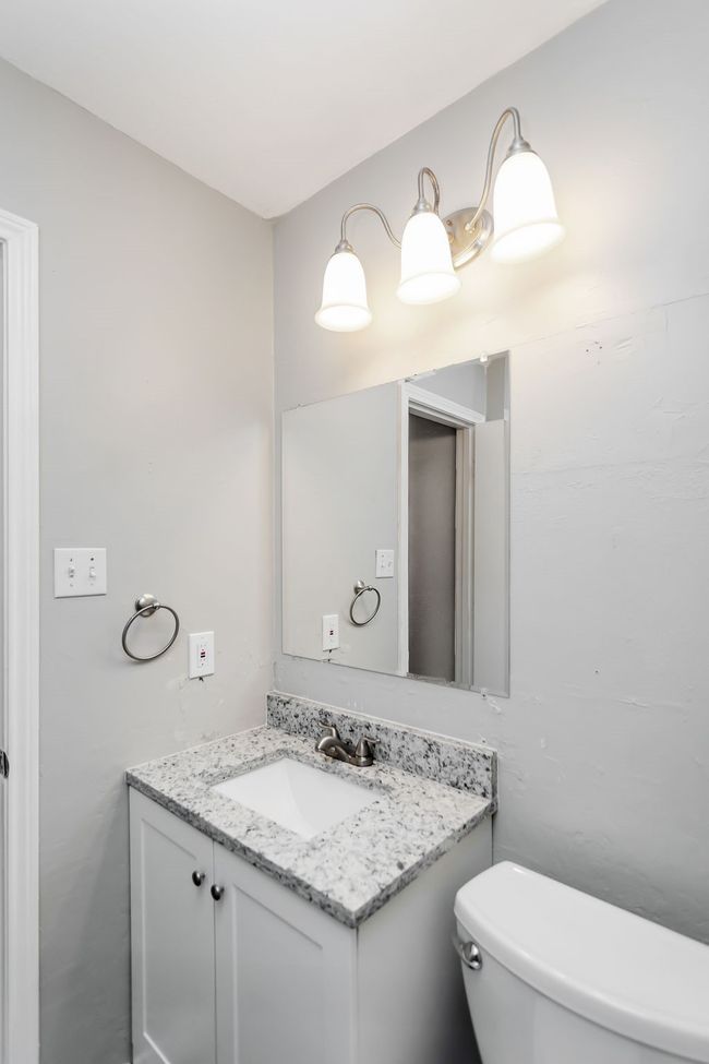 Half bath featuring vanity and toilet | Image 17