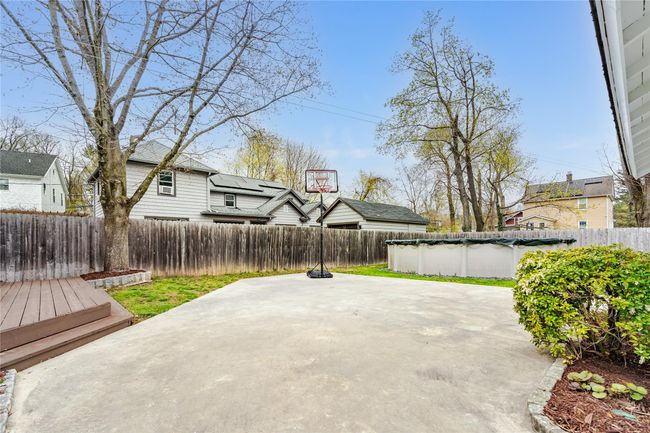 View of patio with a fenced backyard and a fenced in pool | Image 38