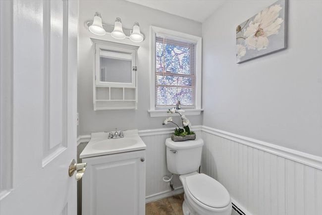 Bathroom featuring a wainscoted wall, toilet, and vanity | Image 29