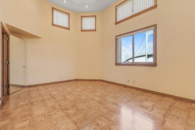 Large Bonus Room featuring high ceilings and water views | Image 21