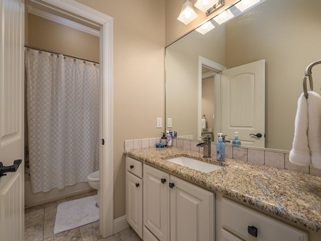 Bathroom with shower / bath combo with shower curtain, vanity, and toilet | Image 31