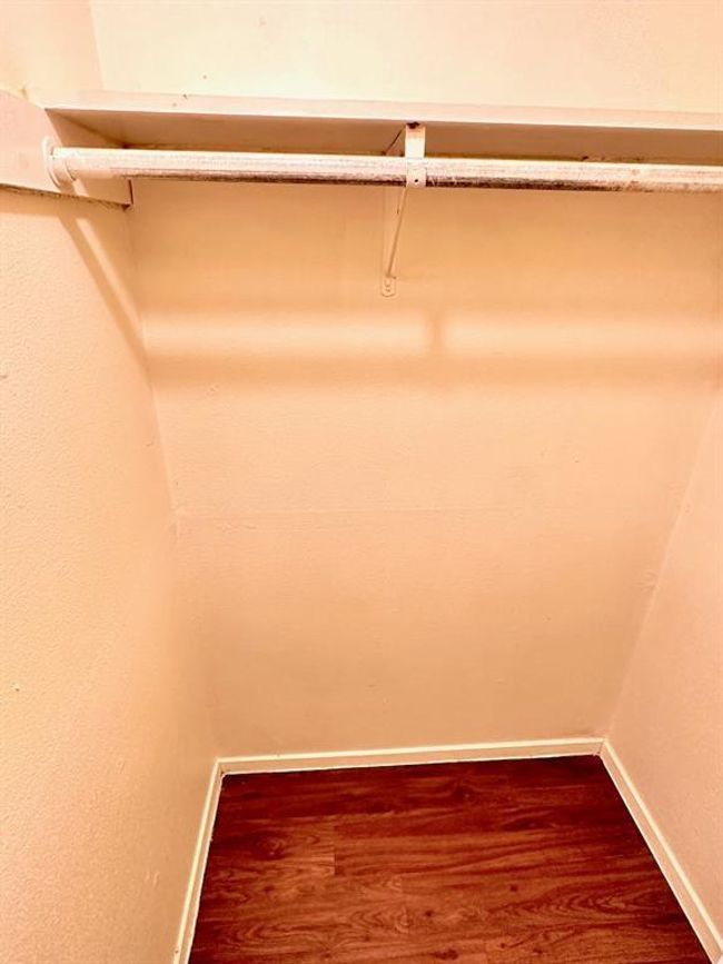 Walk in closet with dark wood-type flooring | Image 9