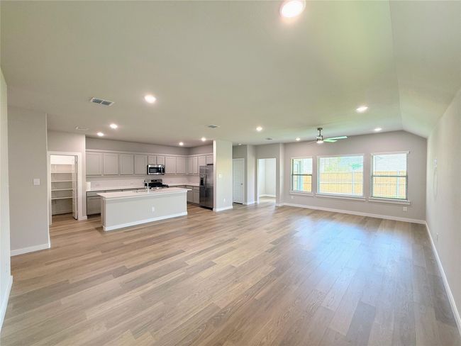 Unfurnished living room featuring baseboards, recessed lighting, light wood-type flooring, and ceiling fan | Image 7