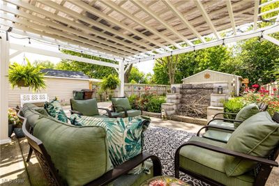 View of patio with pergola and built-in fire pit | Image 3