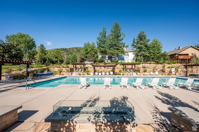 Clubhouse: Community pool featuring fence and a patio | Image 42