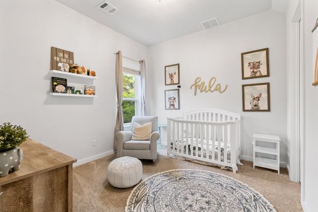 Carpeted bedroom with baseboards and a nursery area | Image 29