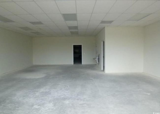 Spare room featuring concrete flooring and a drop ceiling | Image 6