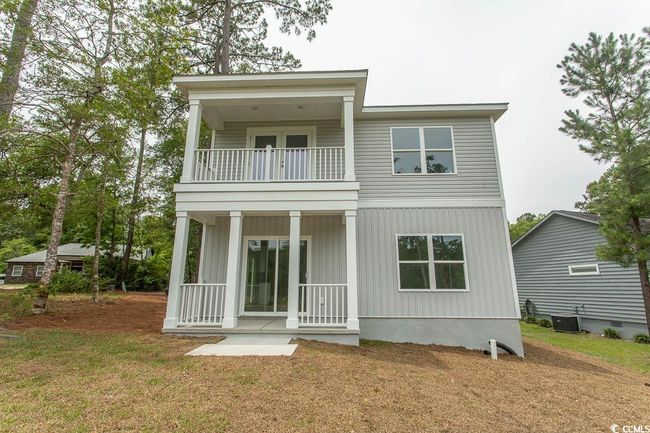 View of rear of home with a balcony and covered porch | Image 39