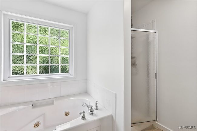 Primary Bathroom with healthy amount of natural light, a stall shower, and a jetted tub | Image 20