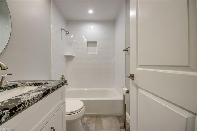 Full bathroom featuring vanity, toilet, and tiled shower / bath | Image 10