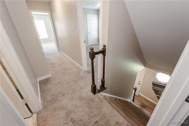 Stairs with baseboards and carpet floors | Image 29