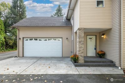 Spacious 2 car garage and inviting covered front porch with easy maintenance aggregate concrete | Image 2