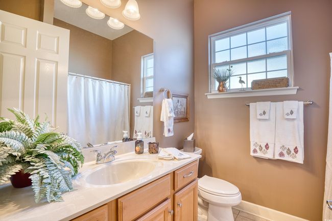 Features a tub/shower combo, vanity, sink, linen closet, and a window. | Image 10