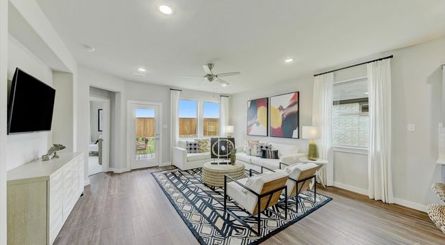Living area with ceiling fan, light wood-style flooring, recessed lighting, and baseboards | Image 7