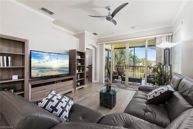 Living room with crown molding, ceiling fan, and light hardwood / wood-style floors | Image 8