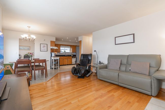 Living room featuring a chandelier and light wood-style floors | Image 11