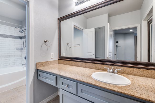 Primary Ensuite Bathroom with tile patterned floors, vanity, and tiled shower / bath | Image 10