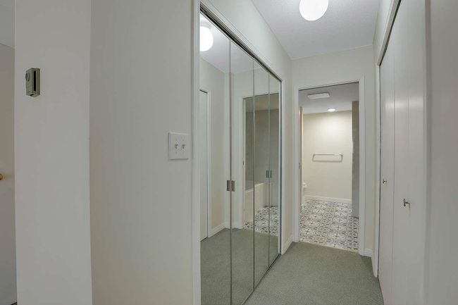 Hall with light carpet and baseboards | Image 24