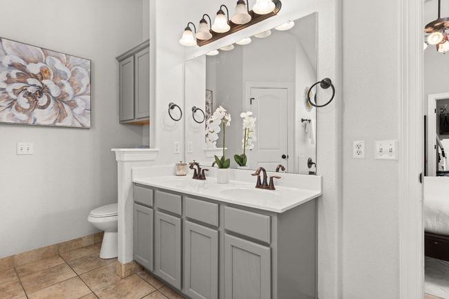 Bathroom featuring double vanity, toilet, and tile patterned floors | Image 16