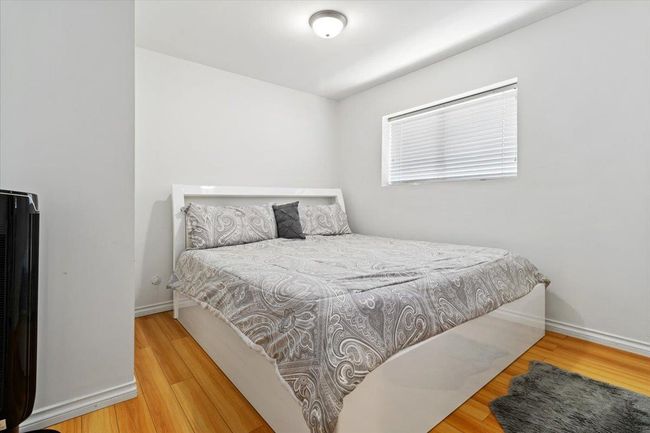 Bedroom with baseboards and wood finished floors | Image 30