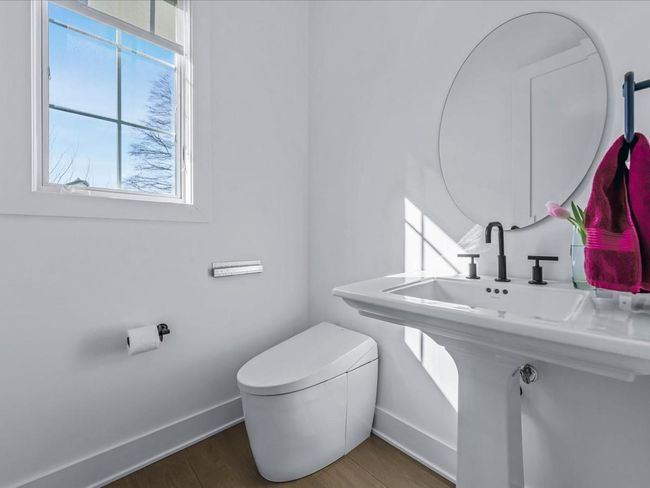 Bathroom with baseboards, wood finished floors, and toilet | Image 15